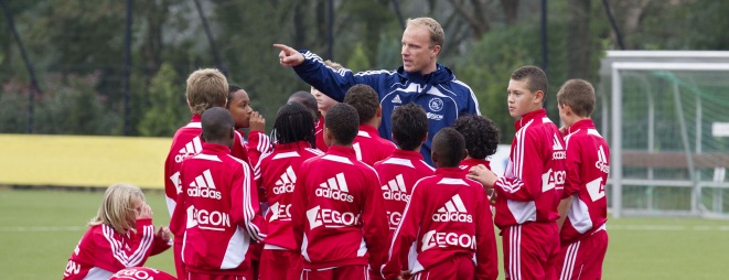 Kids receive instructions from former Dutch international Dennis Bergkamp at an Ajax Talent Camp